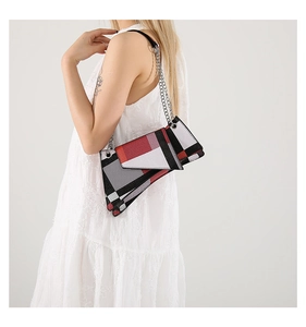 Detail of multi-color geometric patchwork bag with stylish silver chain straps