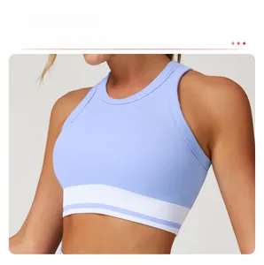 Detail of ribbed yoga tank top featuring light blue fabric and wide elastic support band