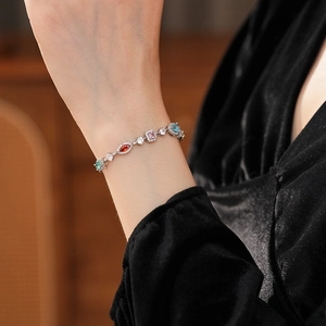 Exquisite floral bracelet featuring multi-colored zircons worn on a model's wrist