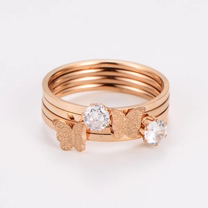 Macro shot of rose gold layered ring with matte butterflies and sparkling cubic zirconia