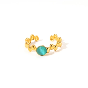 Detail of vintage 18K gold plated beaded ring with a centered teal cat-eye gemstone
