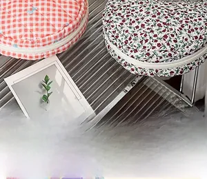 Close-up of quilted floral and red checkered cotton makeup bags on a metal display stand