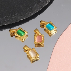 Macro shot of colorful zircon square pendants with beaded gold edges on black rock