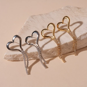 Elegant gold and silver heart tassel earrings with sparkling rhinestones on stone