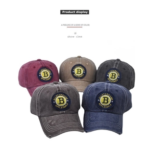 Detail of five washed cotton baseball caps with embroidered B letter and vintage distressing