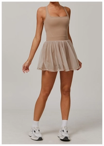 Detail of nude pink athletic dress with breathable mesh skirt and sporty tank top style