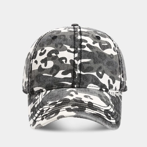 Detailed view of the washed vintage camouflage pattern on a six-panel baseball cap fabric