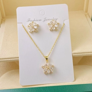 Close-up of golden flower jewelry set with sparkling zircons in a premium gift box
