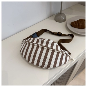 Detailed view of brown and white striped corduroy chest bag with adjustable strap