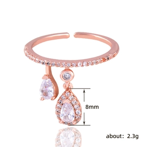 Rose gold adjustable ring with row of diamonds and 8mm pear-shaped water drop charms