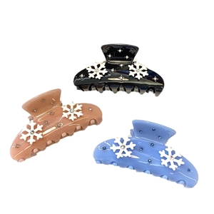Pink and blue acetate hair claws with snowflake patterns and sparkling rhinestones