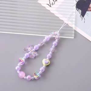 Creative purple acrylic beaded phone strap with bow and heart pendants on grey background