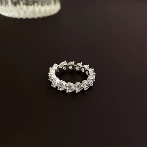 Macro detail of silver eternity ring featuring heart-cut cubic zirconia in a pave setting