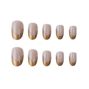Short round French press-on nails in nude pink with irregular gold foil edges