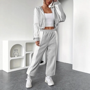 Detail of grey and white contrast stitching on the hooded jacket and high waist joggers set