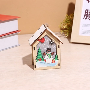 Close-up of a wooden Christmas house pendant featuring snowman and pine tree details