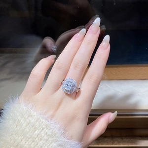 Macro shot of S925 silver moissanite ring with cushion cut diamond and halo setting