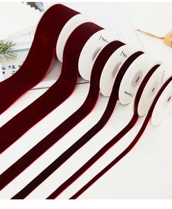 Detail of burgundy velvet ribbons in various widths for gift wrapping and DIY crafts