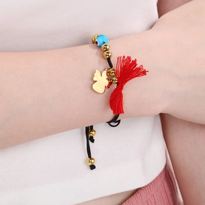 Handmade woven Evil Eye bracelet with gold angel charm and red tassels for women