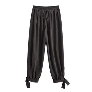 Women's casual loose black lantern pants with elastic waist and bow tie cuffs detail