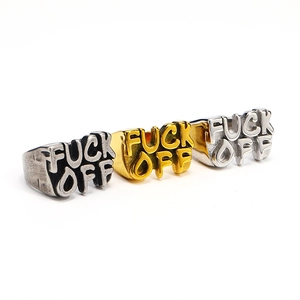 Detailed view of three vintage-style rings in silver and gold with embossed letters