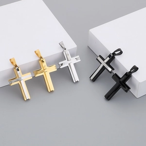 Detail shot of double-layer stainless steel cross pendants in gold, silver, and black