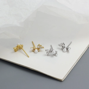Macro detail of elegant s925 silver butterfly earrings with pearls and marquise zircons