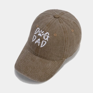 Detailed embroidery of DOG DAD text and paw print on washed brown cotton baseball cap