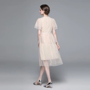 Elegant tulle mesh midi dress with polka dot embroidery and layered floral details in beige