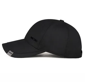 Detail view of the black cotton baseball cap side with metal plate and brim logo