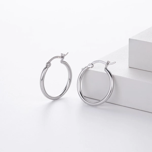Macro shot showing the S925 hallmark on polished silver hollow hoop earrings