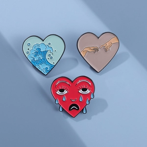 Three-piece heart enamel pin set featuring ocean waves, art gestures, and facial expressions