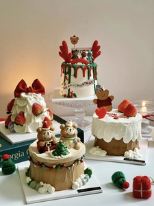Detailed view of assorted Christmas cakes with 3D bears, strawberries and reindeer toppers