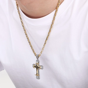 Close-up of a men's dual-tone gold and silver braided chain necklace with a cross pendant