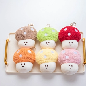 Plush mushroom keychain set in six colors with embroidery and metal hooks on tray