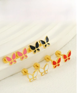 Macro view of colorful enamel butterfly stud earrings with gold screw back closures
