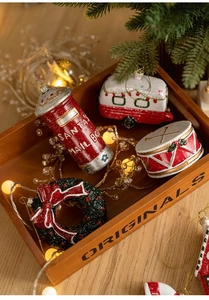 Detail of hand-painted vintage Christmas ornaments featuring a red mailbox and festive wreath