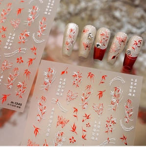 Detail of red bamboo and butterfly nail stickers with metallic finish and calligraphy
