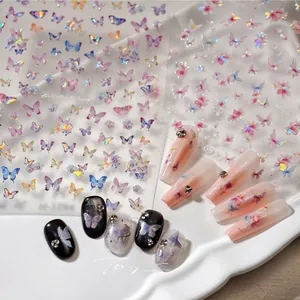 Macro view of butterfly nail stickers with laser effect on ceramic tray display