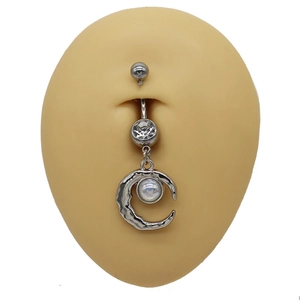 Close-up of silver moon belly ring with sparkling rhinestone and opal on silicone model