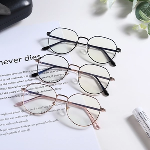 Classic metal round frame glasses in black and rose gold on a minimalist white backdrop