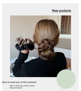 Detail of silk satin scrunchies in beige and brown colors for elegant ponytail hairstyles