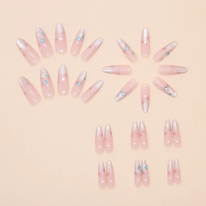 Macro detail of almond press-on nails with silver glitter gradient and blue rhinestones