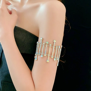 Detailed macro view of sparkling rhinestone arm cuff with cascading crystal fringes