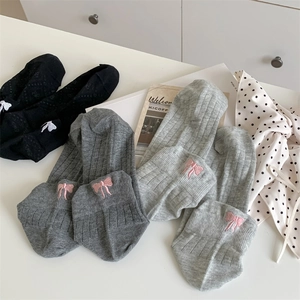 Detail of sweet cotton boat socks featuring bow embroidery and ribbed knit texture