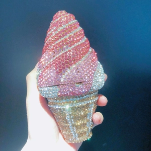 Macro detail of hand-set rhinestones on an ice cream cone shaped evening clutch bag
