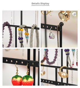 Detail view of a 6-tier black metal jewelry organizer holding earrings and rings