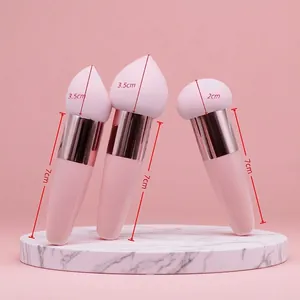Pink makeup sponge set with teardrop and round brush heads on marble stand