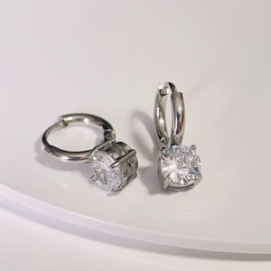 Macro shot of silver zircon hoop earrings with large clear sparkling round stones