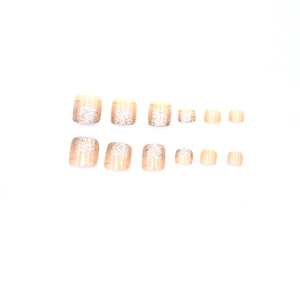Classic nude pink gradient press-on toenails with silver glitter and gold lines
